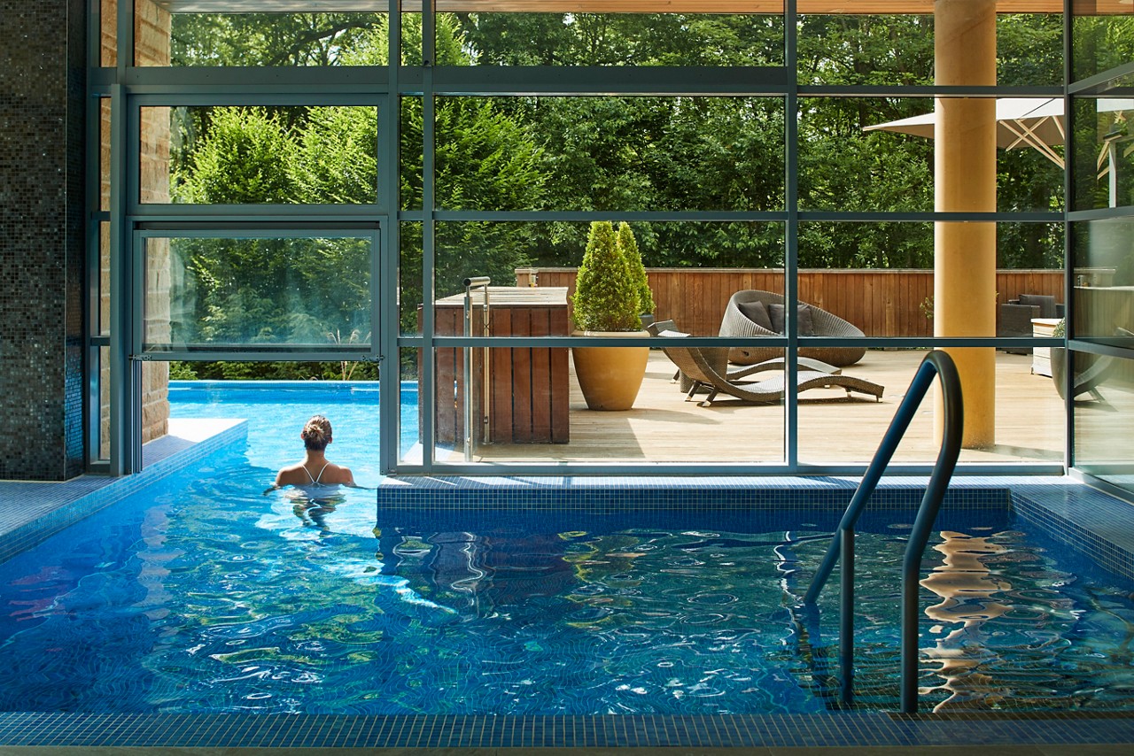 Woman swimming from the Indoor Pool to the Outdoor Pool.