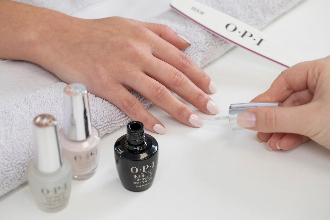 OPI GelColor being applied to a woman's fingernails.
